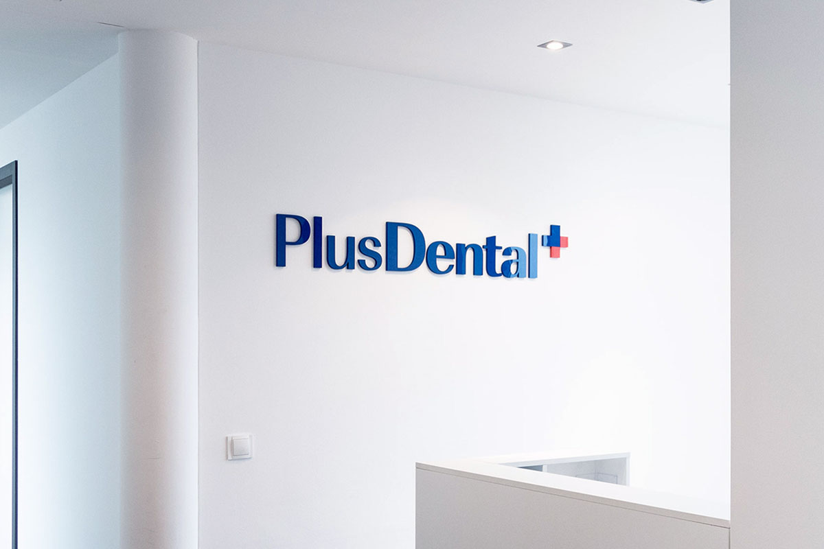 PlusDental-Logo an der Bürowand